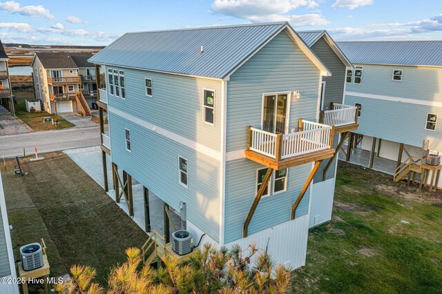146 Sea Gull Ln, North Topsail Beach, NC 28460 - back of property featuring metal roof, central AC unit, and a balcony