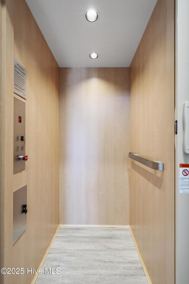 146 Sea Gull Ln, North Topsail Beach, NC 28460 - bathroom featuring baseboards, elevator, and wood finished floors