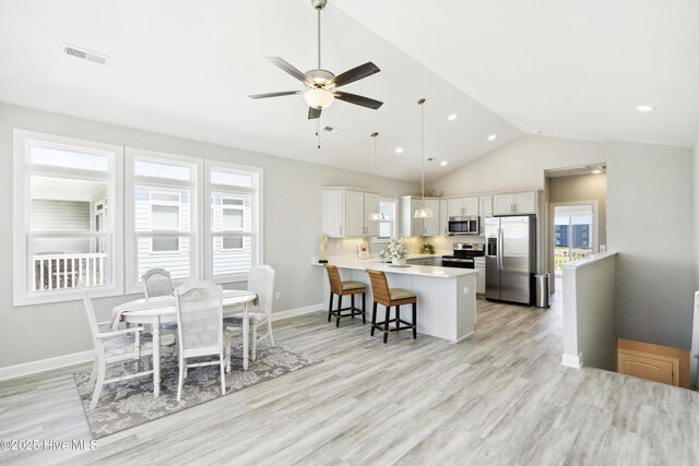 146 Sea Gull Ln, North Topsail Beach, NC 28460 - kitchen featuring visible vents, light wood finished floors, a peninsula, and stainless steel appliances