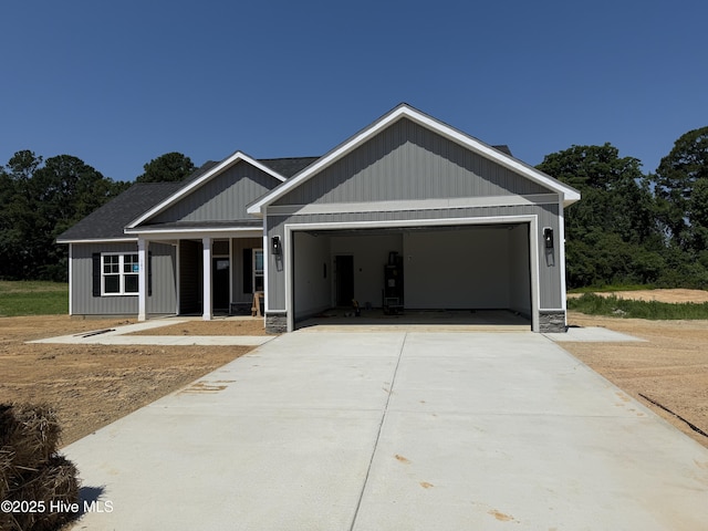107 Tee Dr, Selma, NC 27576 - view of front of house featuring an attached garage, driveway, and covered porch