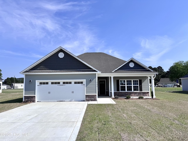 craftsman-style home featuring concrete driveway, a front lawn, stone siding, and a garage