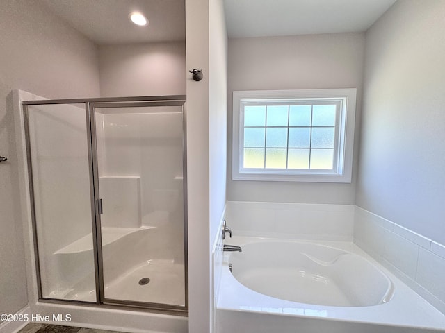 full bath featuring a bath and a stall shower