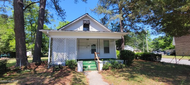 bungalow featuring fence and covered porch