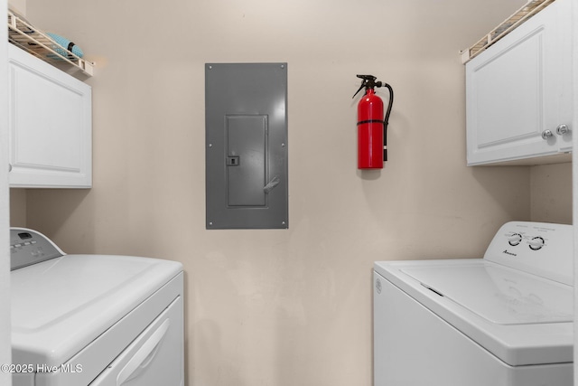 washroom with cabinet space, separate washer and dryer, and electric panel