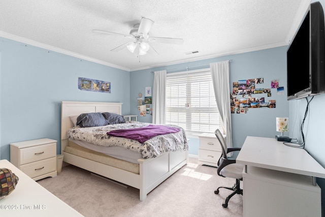 bedroom featuring crown molding, a textured ceiling, visible vents, and light carpet