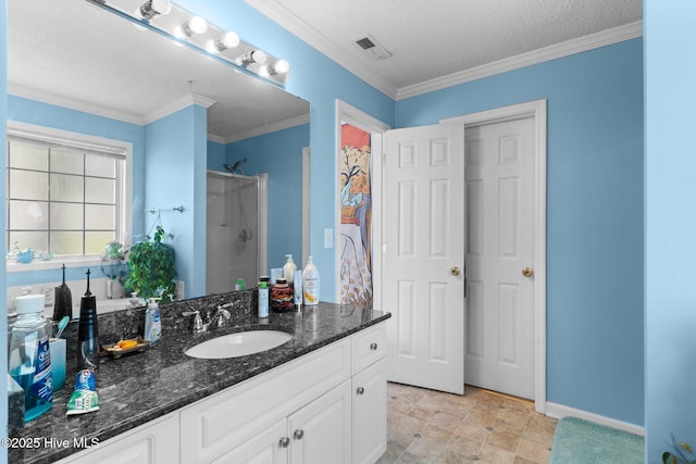 full bath with walk in shower, vanity, a textured ceiling, baseboards, and visible vents