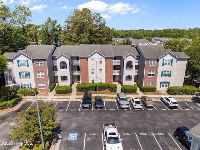 view of property featuring uncovered parking