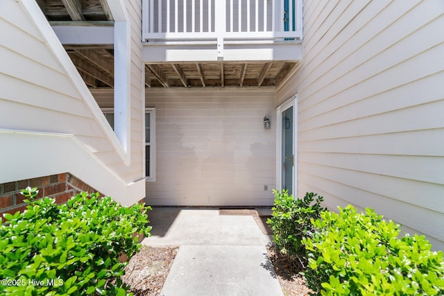 view of exterior entry featuring a balcony