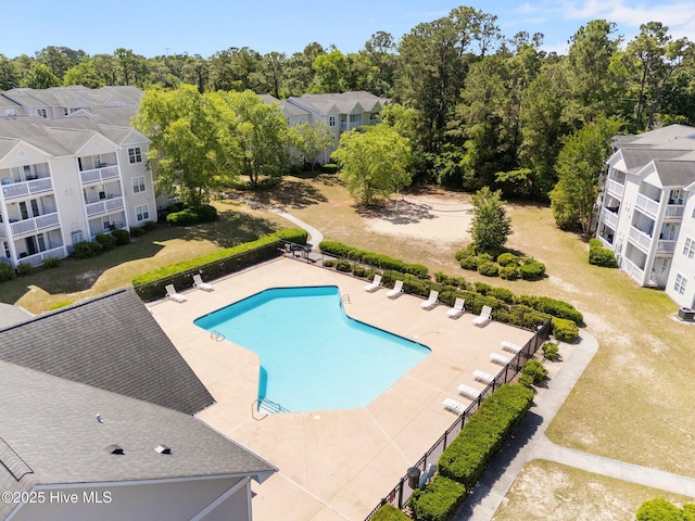community pool with fence and a patio