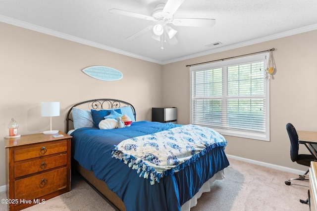 carpeted bedroom featuring baseboards, ornamental molding, ceiling fan, and visible vents