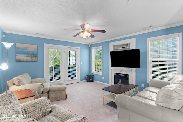 carpeted living room featuring visible vents, a ceiling fan, a high end fireplace, and ornamental molding