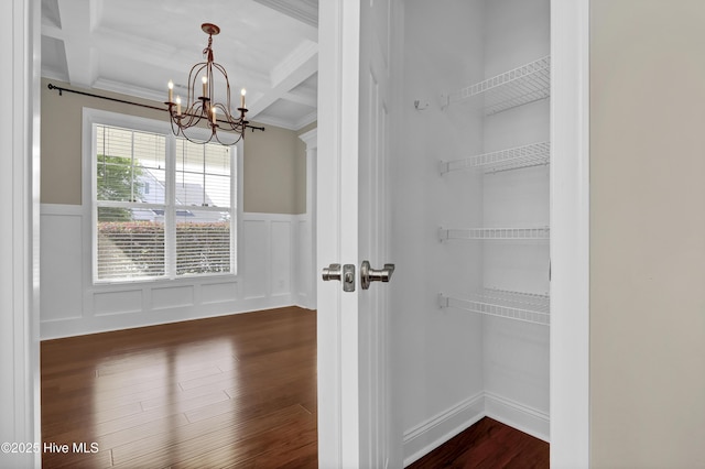 interior space featuring a notable chandelier, dark wood-style floors, beam ceiling, and coffered ceiling