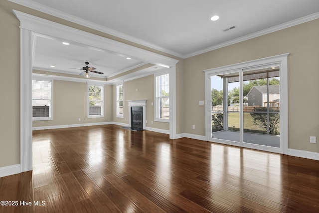 unfurnished living room with a ceiling fan, baseboards, wood finished floors, a high end fireplace, and visible vents