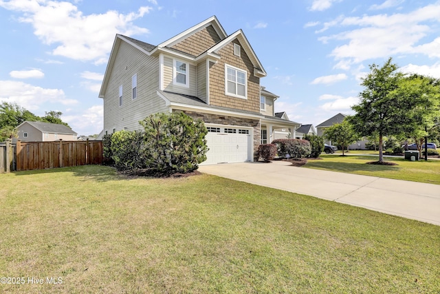 view of front of house featuring fence, a front lawn, stone siding, a garage, and driveway