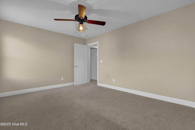 empty room with baseboards, a ceiling fan, and light carpet