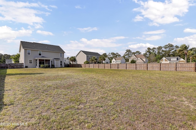 view of yard featuring a fenced backyard and a residential view