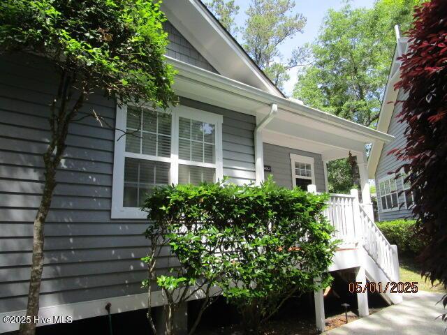 view of property exterior featuring covered porch