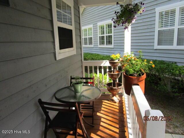 5001 Hewletts Run Unit 2, Wilmington, NC 28409 - doorway to outside with a ceiling fan, wood finished floors, lofted ceiling, and baseboards