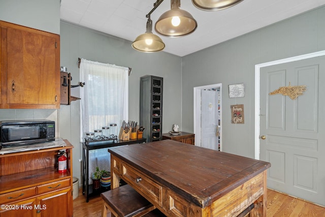 515 E Ridge St, Rose Hill, NC 28458 - kitchen featuring brown cabinets, light wood finished floors, black microwave, and butcher block countertops