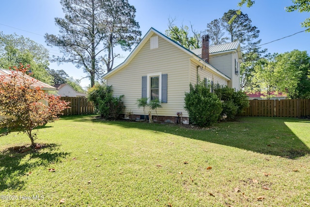515 E Ridge St, Rose Hill, NC 28458 - view of side of property with a chimney and metal roof