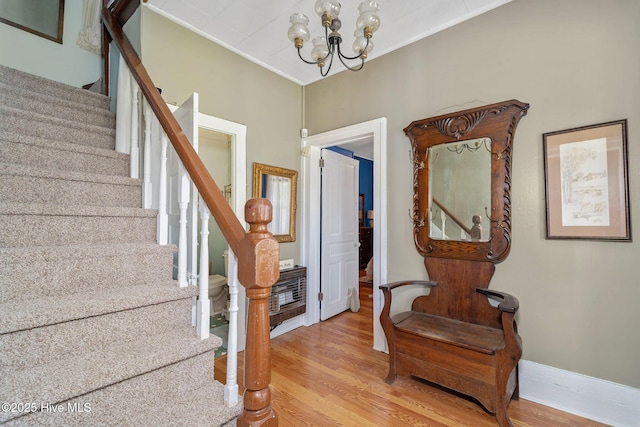 515 E Ridge St, Rose Hill, NC 28458 - stairway featuring a chandelier, wood finished floors, ornamental molding, and baseboards