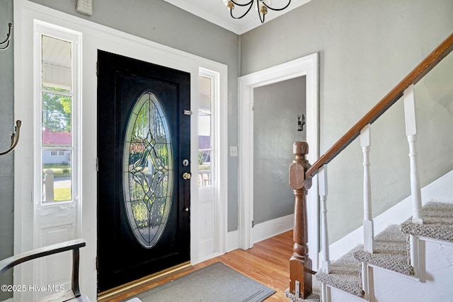 515 E Ridge St, Rose Hill, NC 28458 - foyer entrance with stairway, wood finished floors, a chandelier, and crown molding