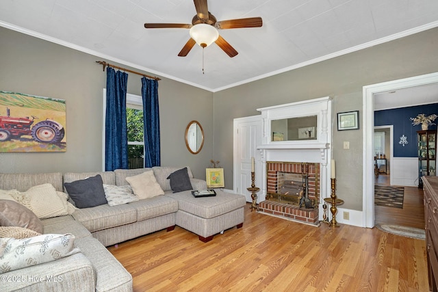 515 E Ridge St, Rose Hill, NC 28458 - living area with light wood-type flooring, ceiling fan, crown molding, and a fireplace
