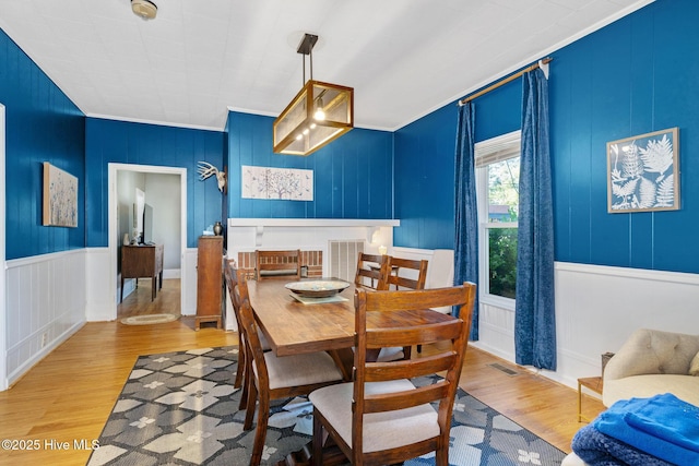 515 E Ridge St, Rose Hill, NC 28458 - dining space featuring wood finished floors, ornamental molding, and a decorative wall