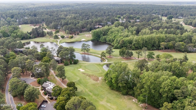bird's eye view with view of golf course, a water view, and a wooded view