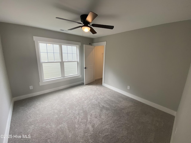 unfurnished bedroom with carpet floors, a ceiling fan, baseboards, and visible vents
