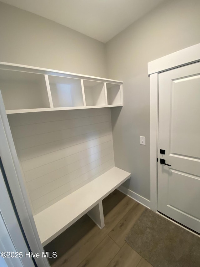 mudroom featuring baseboards and dark wood finished floors