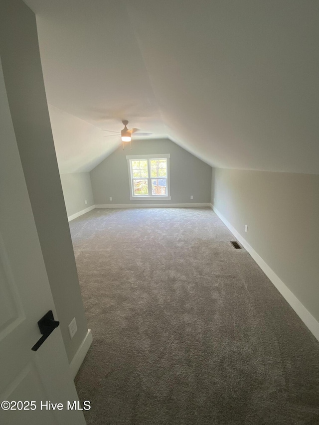 bonus room with a ceiling fan, visible vents, baseboards, lofted ceiling, and carpet