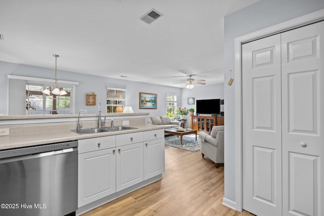 1164 Amber Pines Dr, Leland, NC 28451 - kitchen with a sink, light wood-type flooring, visible vents, dishwasher, and white cabinetry