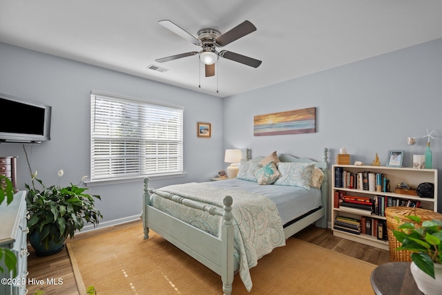 1164 Amber Pines Dr, Leland, NC 28451 - bedroom with baseboards, a ceiling fan, visible vents, and wood finished floors