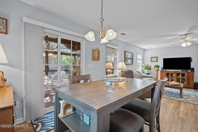 1164 Amber Pines Dr, Leland, NC 28451 - dining space with light wood-type flooring, visible vents, baseboards, and ceiling fan with notable chandelier