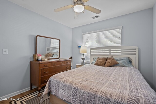 1164 Amber Pines Dr, Leland, NC 28451 - bedroom featuring baseboards, a ceiling fan, visible vents, and wood finished floors
