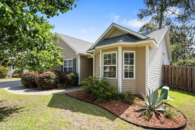1164 Amber Pines Dr, Leland, NC 28451 - view of front of home featuring a front lawn, a shingled roof, and fence