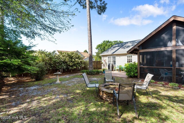 1164 Amber Pines Dr, Leland, NC 28451 - view of yard featuring a sunroom, fence, and a fire pit