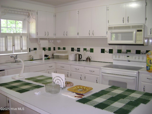 501 US-13, Windsor, NC 27983 - kitchen featuring light countertops, white cabinets, backsplash, and white appliances