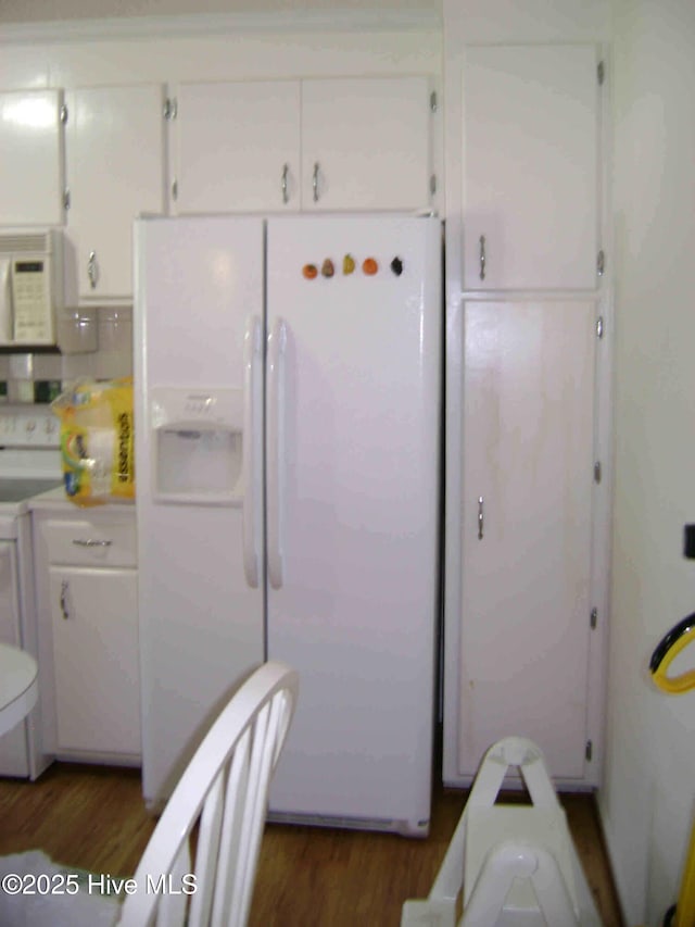 501 US-13, Windsor, NC 27983 - kitchen featuring white cabinetry, wood finished floors, and white appliances