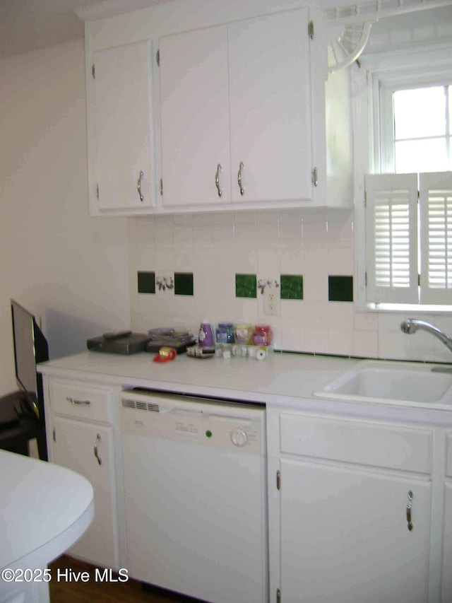 501 US-13, Windsor, NC 27983 - kitchen featuring white cabinets, a sink, dishwasher, light countertops, and a wealth of natural light