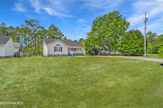 142 Burton Rd, Southport, NC 28461 - view of front facade featuring covered porch, fence, and a front lawn