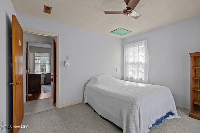 bedroom with carpet flooring, a ceiling fan, baseboards, and a textured ceiling