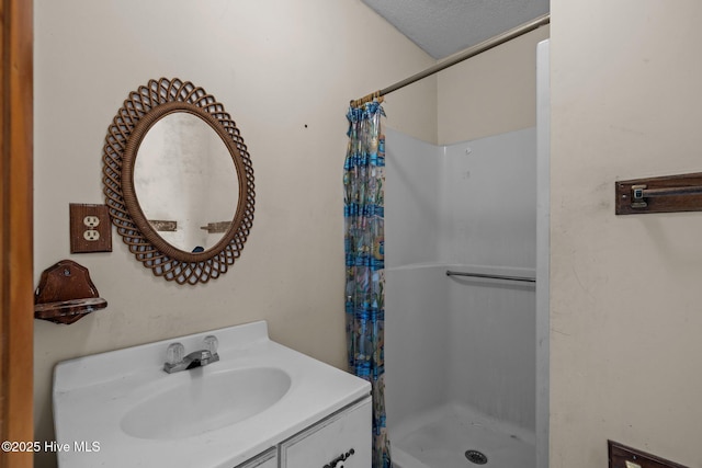 bathroom featuring a shower stall and vanity