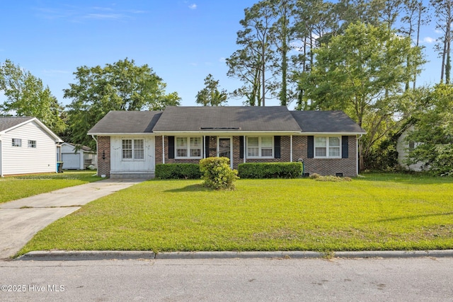 ranch-style house featuring brick siding and a front lawn