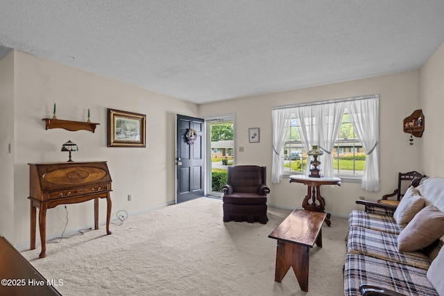 carpeted living room featuring a textured ceiling and baseboards