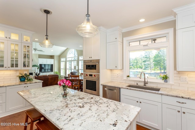 kitchen featuring white cabinets, appliances with stainless steel finishes, and a sink