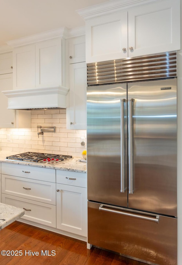 118 Dennis Cir W, End, NC 27376 - kitchen featuring appliances with stainless steel finishes, white cabinetry, tasteful backsplash, and light stone counters
