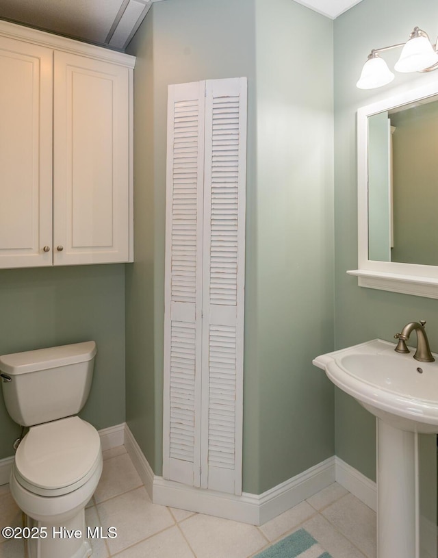 118 Dennis Cir W, End, NC 27376 - half bathroom featuring tile patterned floors, toilet, baseboards, a sink, and a closet