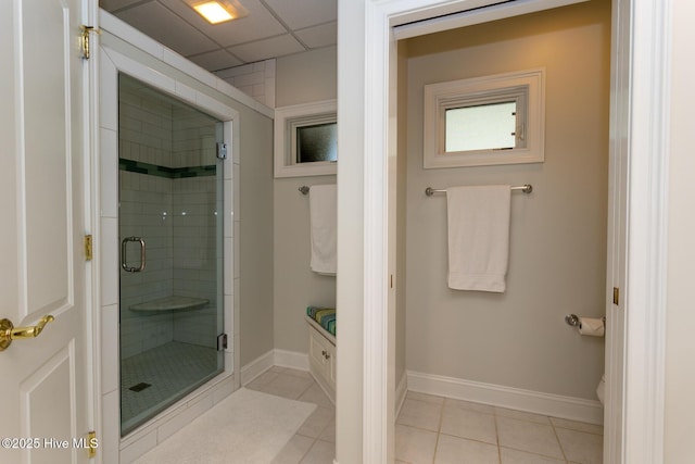 full bath featuring baseboards, a shower stall, tile patterned flooring, and vanity